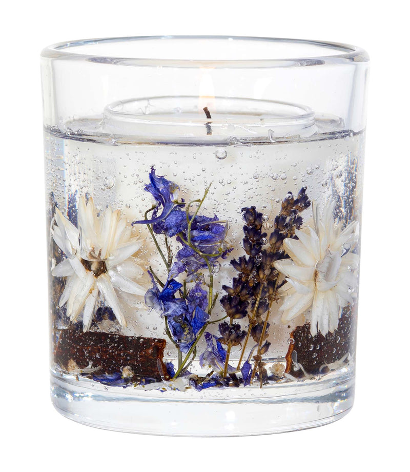 Close-up of Stoneglow Nature's Gift Lilac and Lavender botanical candle showing dried florals set in gel tumbler with lit wick