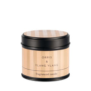Stoneglow Modern Classics Orris and Ylang Ylang black candle tin with warm blush label, lid on, shown on white background