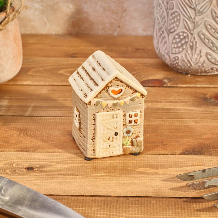 Rustic stoneware garden shed tealight holder with heart cutout, pastel bunting and flower pot detail, Stoneware Country Cottage Collection