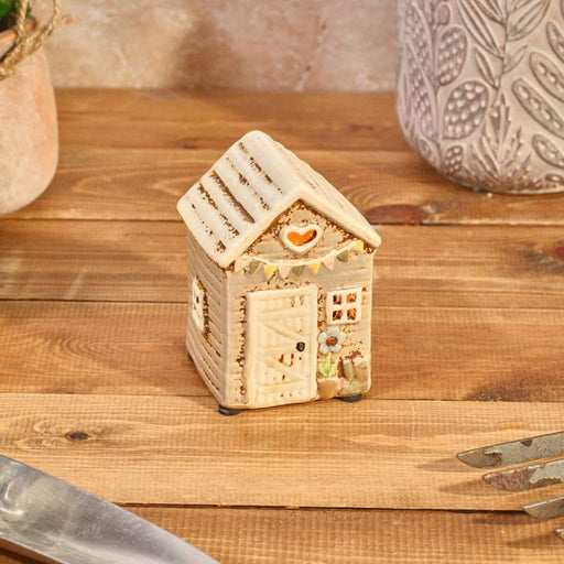 Rustic stoneware garden shed tealight holder with heart cutout, pastel bunting and flower pot detail, Stoneware Country Cottage Collection