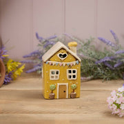 Yellow stoneware cottage tealight holder with heart cutout, embossed pastel bunting and potted topiary trees, Stoneware Country Cottage Collection