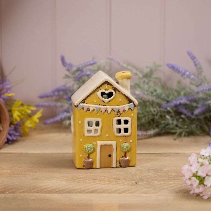 Yellow stoneware cottage tealight holder with heart cutout, embossed pastel bunting and potted topiary trees, Stoneware Country Cottage Collection
