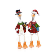 Mr and Mrs Christmas duck decorations with dangling legs — Mrs Duck in Santa hat with gift and blue bag, Mr Duck in top hat with lantern, white background