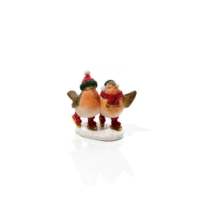 White background: Resin ice skating robin pair Christmas ornament with hats and scarves on white snowy base, white background