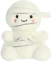Brendan the Mummy Palm Pal a spooky-cute cream plush wrapped in bandage-style detail with dark stitch lines shiny black eyes rosy cheek circles and a sweet smile shown from the front