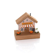 Pumpkin Spice café house wooden ornament with striped awning, painted windows, miniature pumpkins and chalkboard sign on a natural wood base, white background