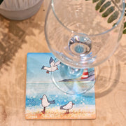 Seagull and Lighthouse ceramic coaster with wine glass showing coastal scene with seagulls and lighthouse