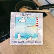Seagull and Lighthouse ceramic trivet with cork backing, shown in gift box, 20x20cm