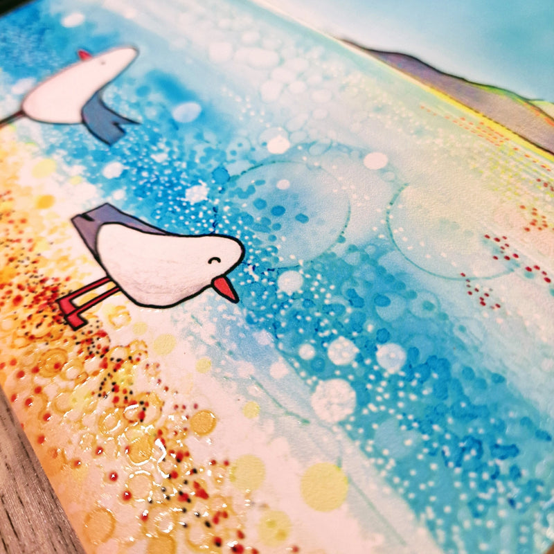 Close-up of seagull and lighthouse coastal scene on ceramic trivet surface