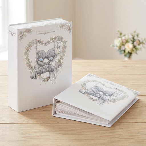 Tatty Teddy wedding photo album and matching box displayed on a light wood table.