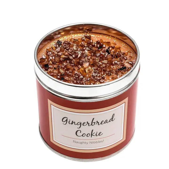 Gingerbread Cookie scented candle in a tin with bronze sparkly topping, label reading "Gingerbread Cookie — Naughty Nibbles!", white background