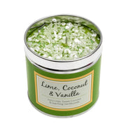 Lime, Coconut & Vanilla scented candle in a green tin with sparkly topping, label reading "Lime, Coconut & Vanilla — Juicy Lime, Sweet Coconut & warming Vanilla pods", white background