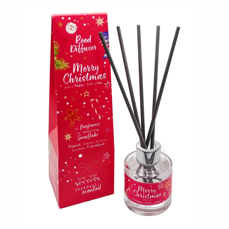 Merry Christmas reed diffuser in Sparkling Snowflake fragrance with black reeds, presented alongside a festive red Merry Christmas and Happy New Year gift box