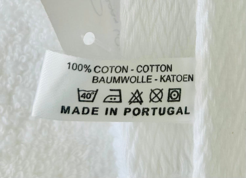 Care label showing 100% cotton, machine washable at 40 degrees, made in Portugal