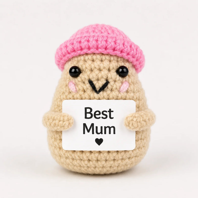 Best Mum Positive Crochet Gift character wearing a pink beanie hat holding a Best Mum sign, presented on a white background