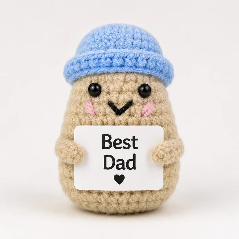 Best Dad Positive Crochet Gift character wearing a blue beanie hat and holding a Best Dad sign, presented on a white background