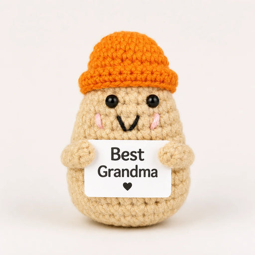 Best Grandma Positive Crochet Gift character wearing an orange beanie hat and holding a Best Grandma sign, presented on a white background