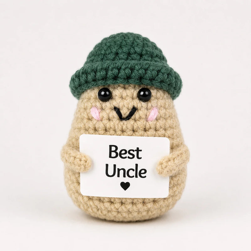Best Uncle Positive Crochet Gift character wearing a dark green beanie hat and holding a Best Uncle sign, presented on a white background