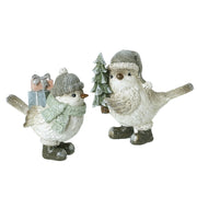 Two Christmas bird figurines with sparkly finish — one in a bobble hat and sage scarf carrying glittery gift boxes, one in a grey santa hat and chunky boots holding a glittery Christmas tree