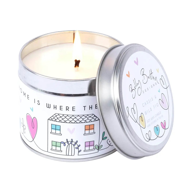 Home Is Where The Heart Is Fig & Cassis soy lit candle 195g, with lid leaning against the candle on a white background

