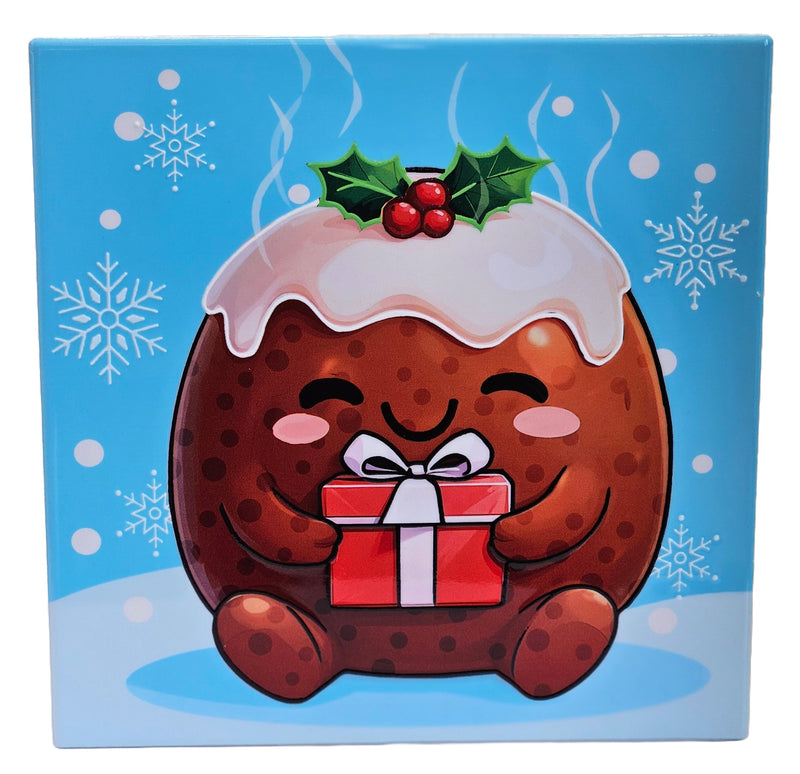 Square Christmas trivet featuring a smiling Christmas pudding holding a ribbon-tied present, topped with icing, holly and berries, with snowflakes in the background