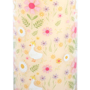 Close-up of daisy and duck floral print on vanilla scented glass tube candle showing white ducks, daisies and wildflowers pattern