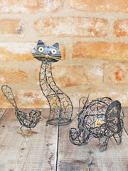 Open ironwork cat ornament handmade in Bali shown with bird and elephant ornaments from the same range, twisted wire with gold-coloured details