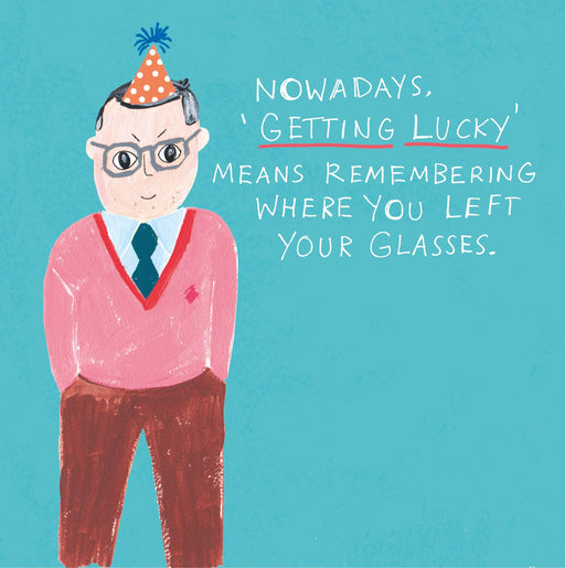 Funny birthday card with an illustrated man in a pink jumper and party hat on a teal background, with the text "Nowadays, 'Getting Lucky' means remembering where you left your glasses"