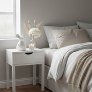 Large ceramic standing mouse in white on a bedside table