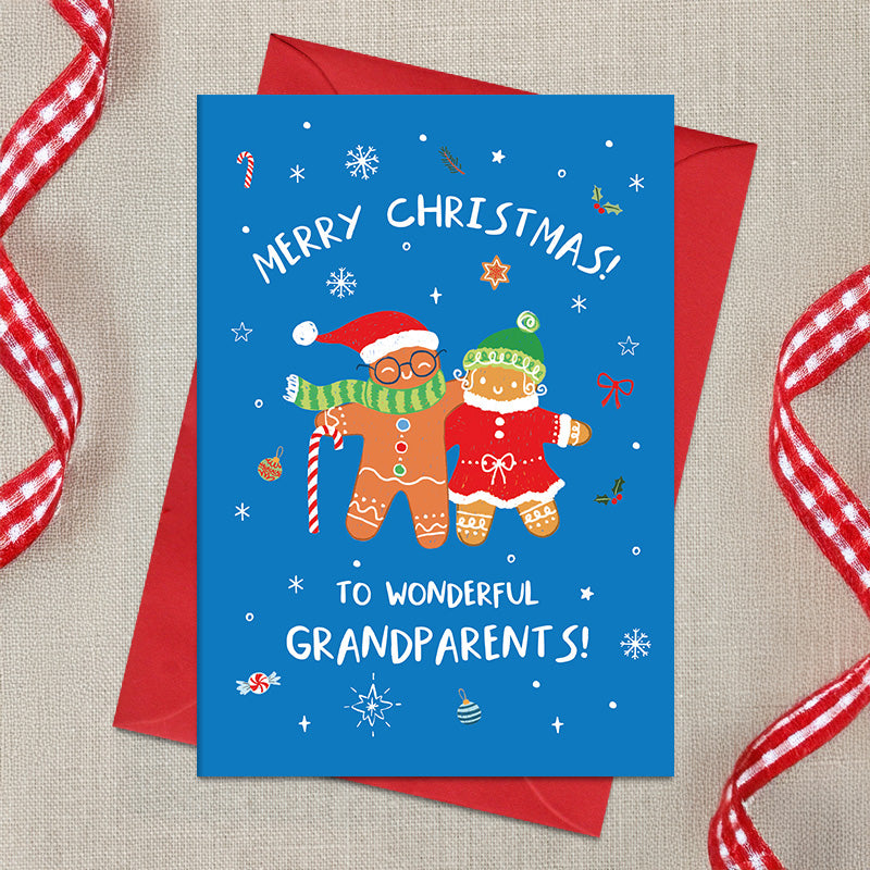 Wonderful Grandparents Christmas card featuring two illustrated gingerbread characters in festive hats and clothing, surrounded by snowflakes and decorations, with a Merry Christmas greeting