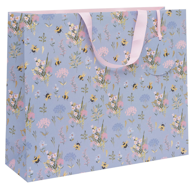 Stephanie Dyment Bee Meadow Blue landscape shopper gift bag with bumblebee and wildflower design on soft blue background with pink ribbon handles on white background