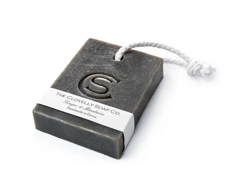 Clovelly Soap Co. Ginger & Mandarin handmade bar soap on a rope with white cotton cord, cold-process charcoal-toned bar with embossed logo, handcrafted in Devon
