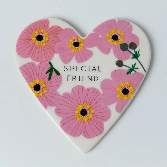 Special Friend heart-shaped porcelain coaster with pink cosmos flower design and gift box, front view on white background