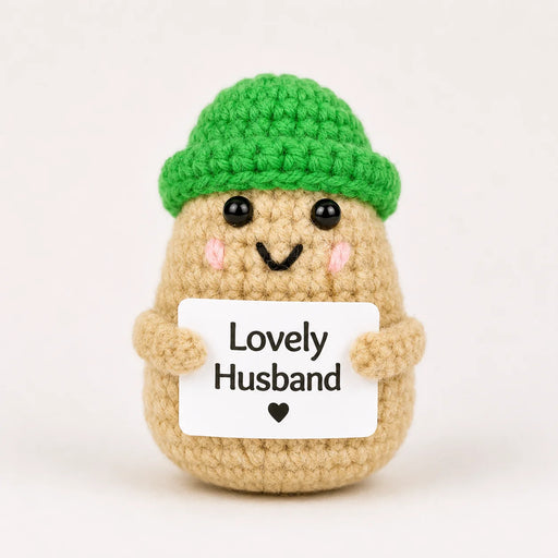 Lovely Husband Positive Crochet Gift character wearing a bright green beanie hat and holding a Lovely Husband sign, presented on a white background
