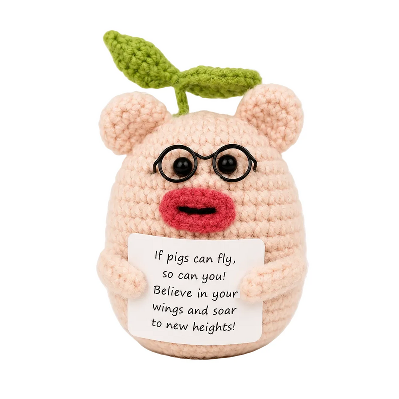 Pig with Glasses Positive Crochet Gift character wearing round glasses with a green leaf on top, holding an If pigs can fly so can you message, presented on a white background