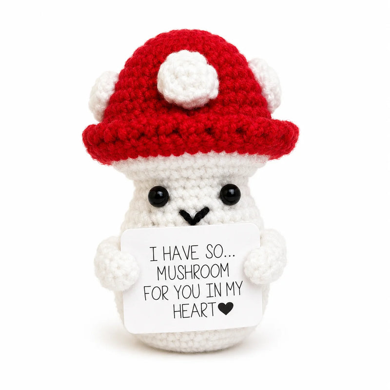 Mushroom Positive Crochet Gift character with a red cap and white spot details holding an I have so mushroom for you in my heart message, presented on a white background