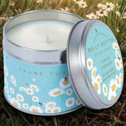 Thank You Daisies soy wax candle in a gift tin, surrounded by daisies — Lemon Verbena scented, hand-poured in the UK