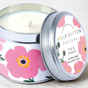 Pink Cosmos Fig & Cassis soy wax candle in bold floral silver tin, styled on a wooden surface