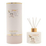 The Little Things Home glass reed diffuser with white reeds and gold collar next to white cylindrical gift box on white background, vanilla and tonka fragrance