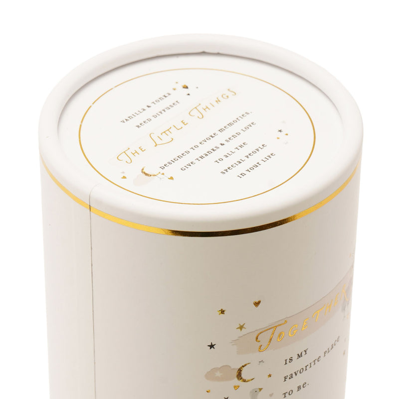 The Little Things reed diffuser cylindrical gift box lid close-up showing gold foil branding and collection description text