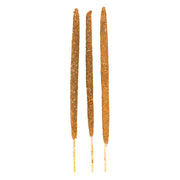 Three thick handmade Champa and Olibanum incense sticks laid flat, white background