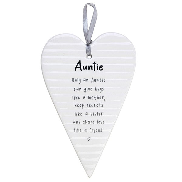 White hanging heart plaque with grey satin ribbon printed with Auntie sentiment verse reading "Only an Auntie can give hugs like a mother, keep secrets like a sister and share love like a friend"