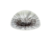 Dahlia glass paperweight viewed from the side showing the domed profile and monochrome floral print, white background
