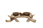Woodland bird double tealight holder with two birds perching on a curved branch with pine cone tealight cups and pine cone decorations, plain white background