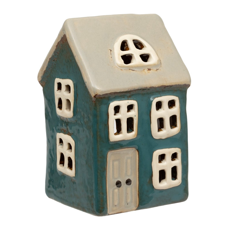 Holly Cottage Tealight Holder, teal two-storey ceramic cottage with cream roof, arched dormer window, multiple white-framed windows and cream panelled door, warm tealight glow through windows, on white background
