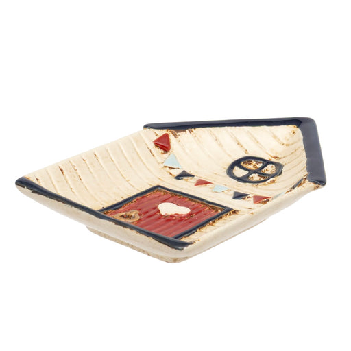 Beach Hut Ceramic Trinket Dish top view showing cream textured body, navy roof, red door with heart detail and bunting garland in navy red and pale blue, on white background