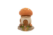 Toadstool House Ornament polyresin figurine with spotted toadstool cap roof wooden door round window stone steps and toadstools at the base on white background