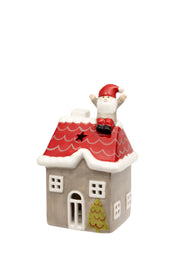 Santa on the Rooftop LED House grey ceramic LED house with red tiled roof Santa figure sitting on the rooftop with arms raised star cut-out windows arched front door and Christmas tree detail on white background