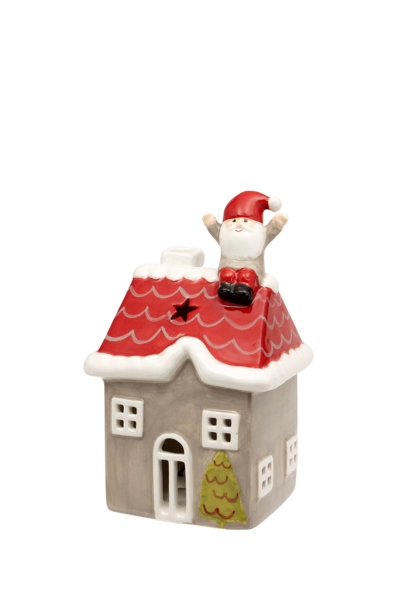 Santa on the Rooftop LED House grey ceramic LED house with red tiled roof Santa figure sitting on the rooftop with arms raised star cut-out windows arched front door and Christmas tree detail on white background