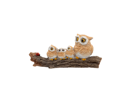 Owl Family on Log Figurine polyresin figurine of parent owl and three owlets perched on a textured log with a ladybird detail on white background